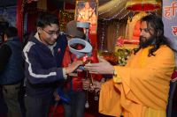 Swamiji distributing assistive devices and necessary equipments to differently abled people