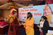 Swamiji distributi​ng Hearing Aids to hearing impaired people at Shyama Shyam Dham Thimi,2070-09-15